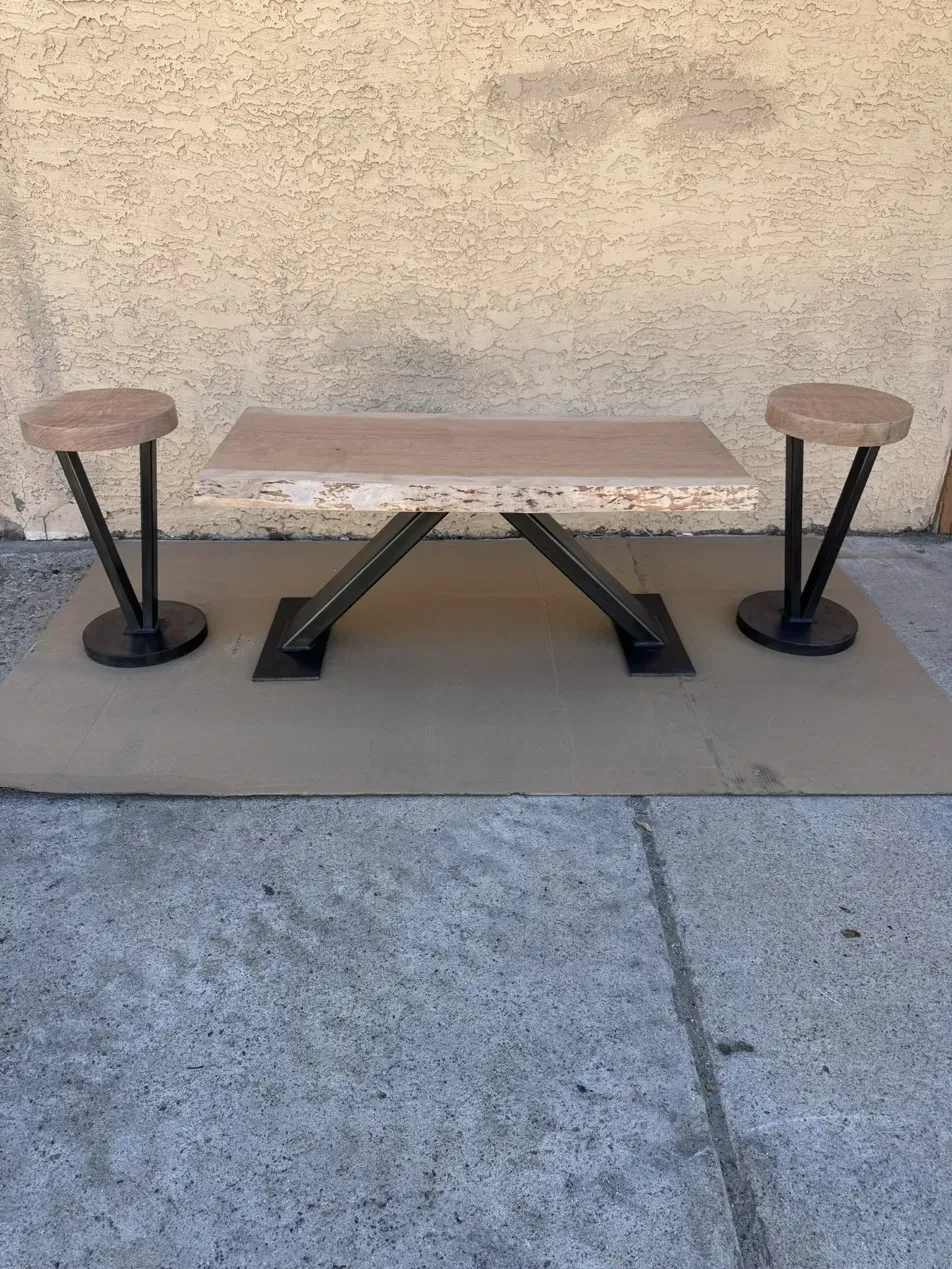 Cherry slab table and two round stools on custom black steel bases