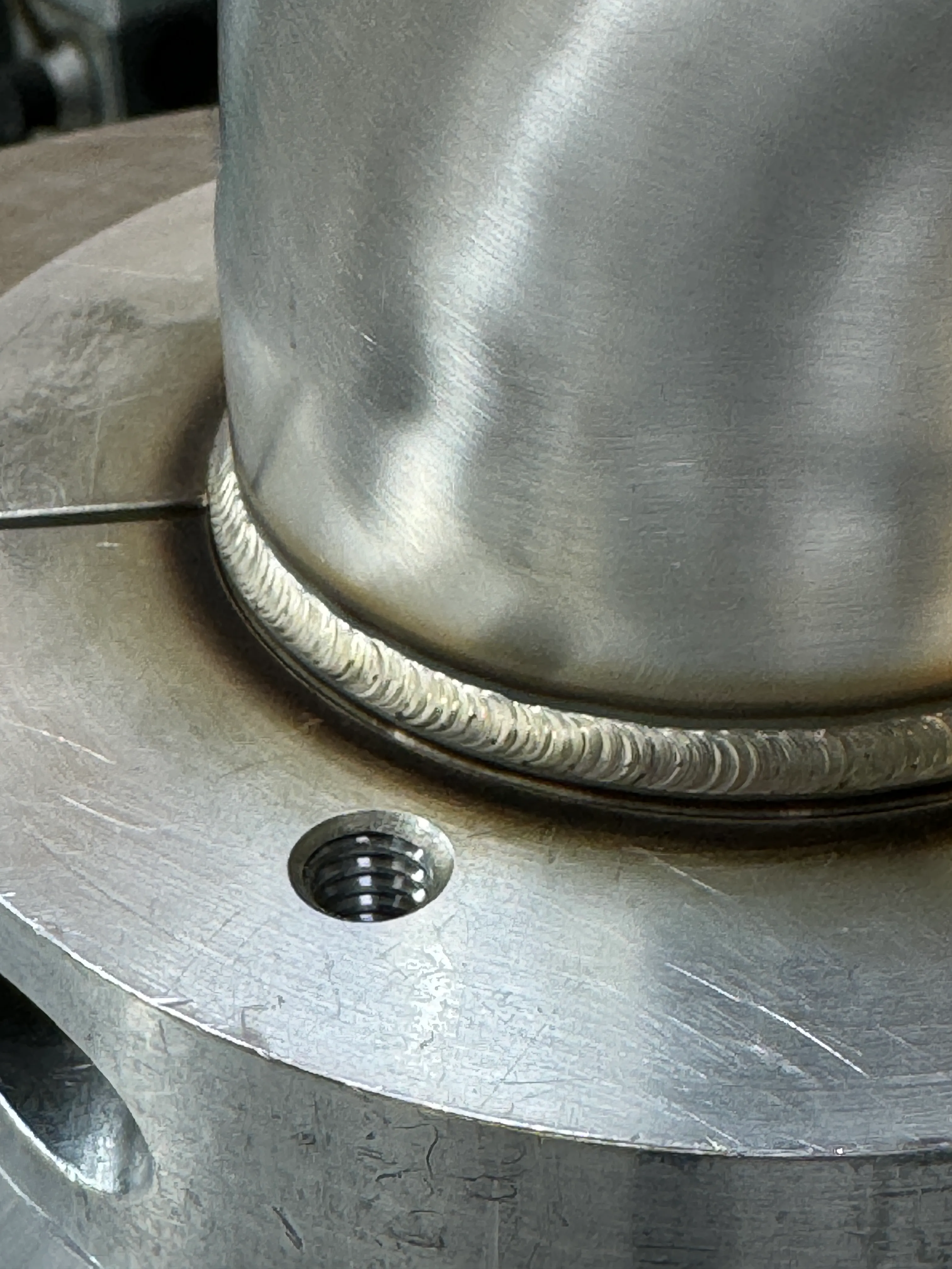 Close-up of a consistent TIG weld on a round component