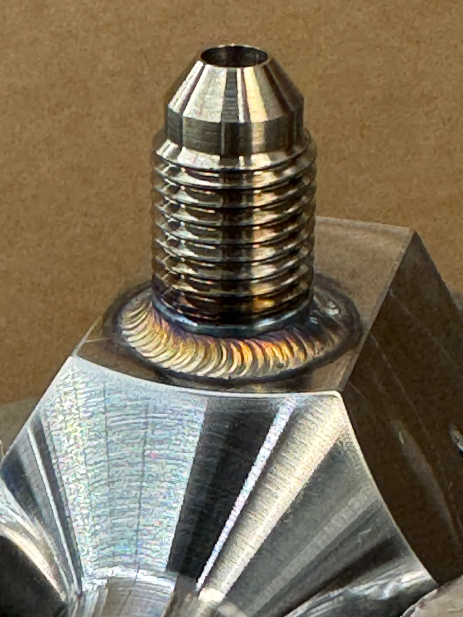 Threaded fitting joined with a precise circular weld